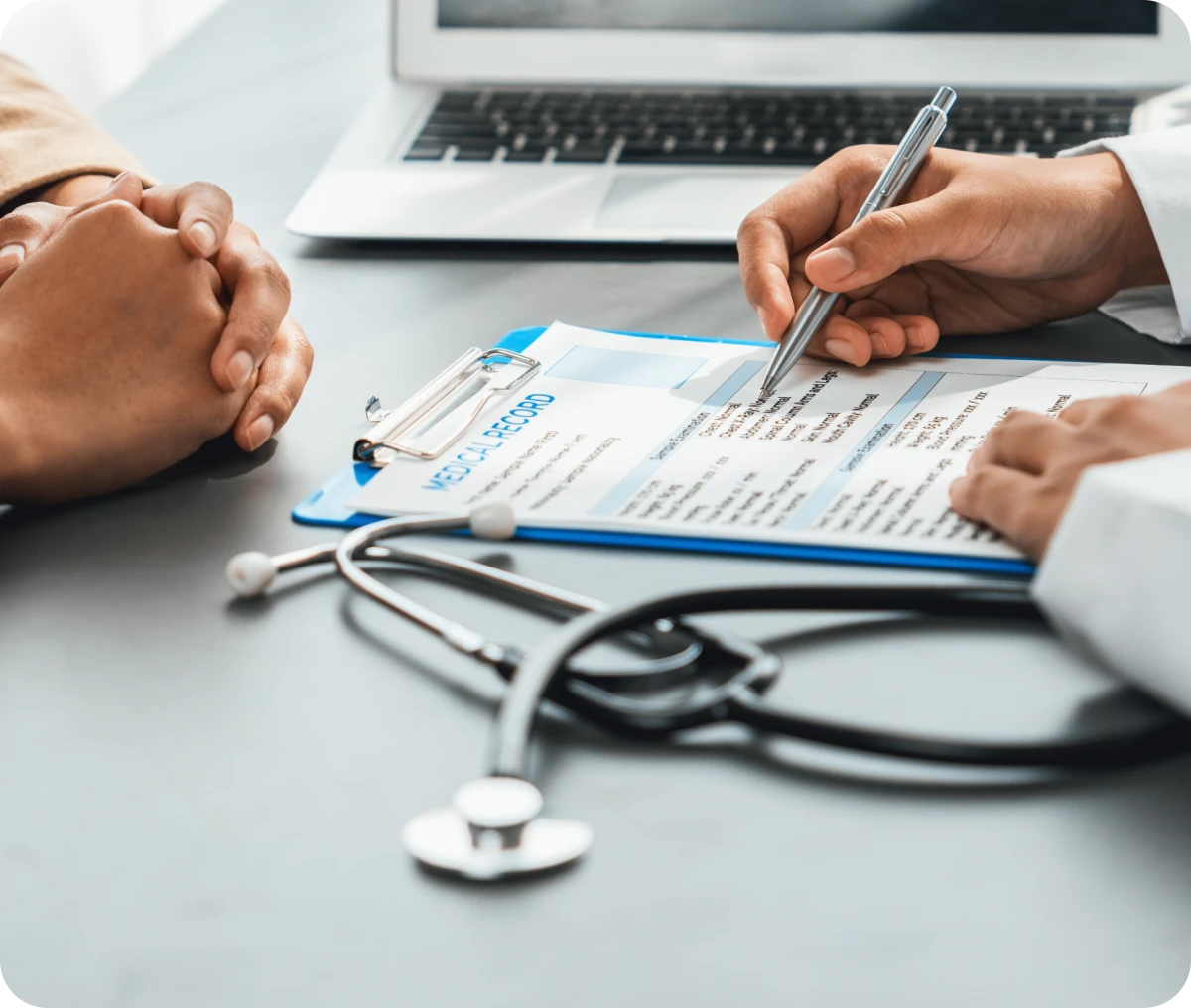 Doctor discussing medical chart with patient.
